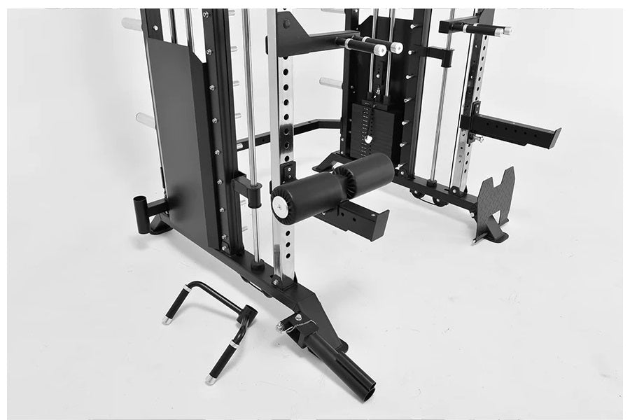 Black and white multi-function power rack with cable pulley system, smith machine rails, and leg press attachment on white ba