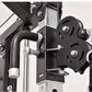 Black and silver home gym cable pulley system with weight plates, handle grips, and metal frame structure on white background