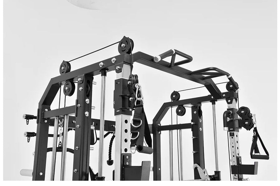 Black and white multi-station home gym with cable pulleys, smith machine, and functional trainer on white background