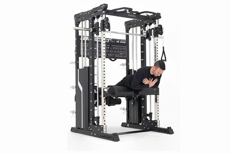 Man in black shirt using black and white multi-station home gym machine with cable pulleys and smith bar on white background