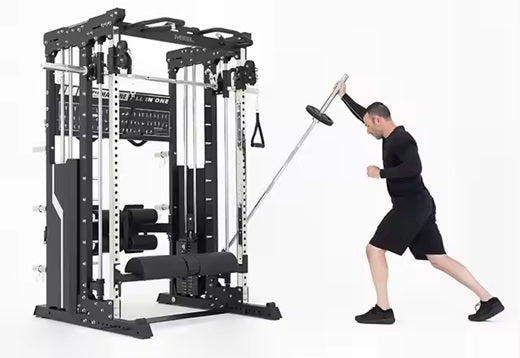 Black and white metal all-in-one power rack home gym with cable pulleys, shown with man in black workout clothes performing e