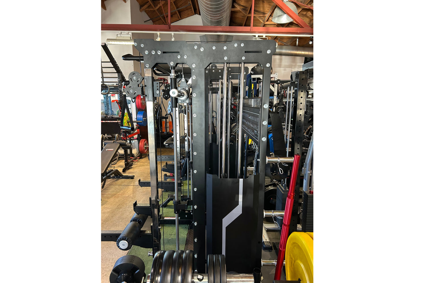 Warrior 901 black all-in-one power rack with cable pulleys, smith machine, and counter-balanced system in gym setting