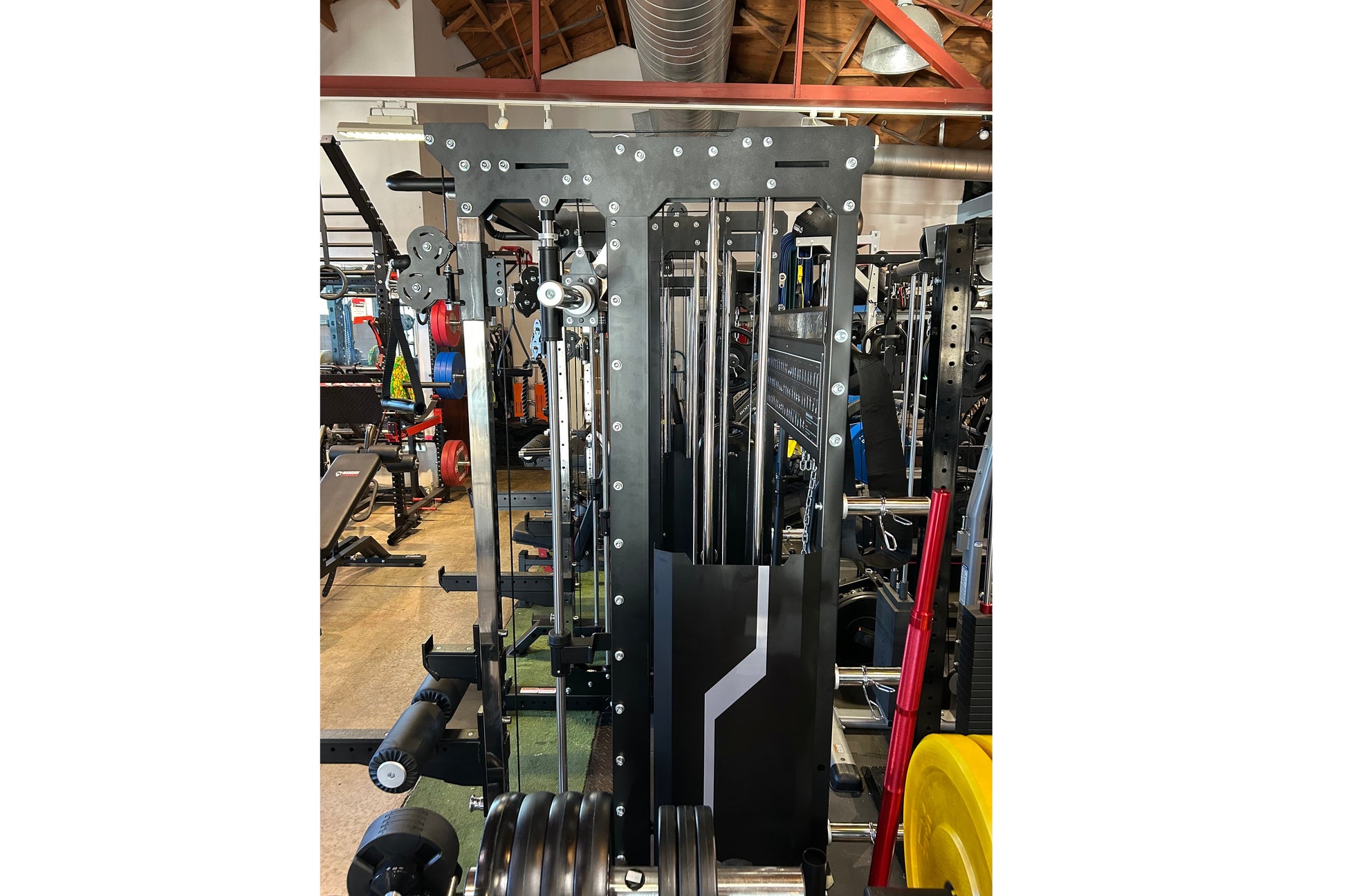 Warrior 901 black all-in-one power rack with cable pulleys, smith machine, and counter-balanced system in gym setting