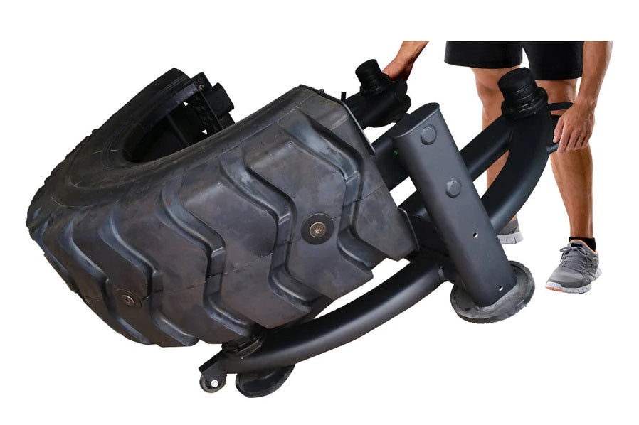 Warrior 180 Tire Flip XL with textured black rubber tire and steel frame, shown being handled by person in athletic wear