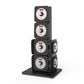 Four-tier black dumbbell rack with stacked adjustable weight plates, each featuring silver dials and Warrior branding, on bla