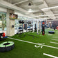 Warrior Agility Turf artificial grass flooring in modern gym space with exercise equipment and white lane markings