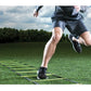 Athlete running through agility ladder on green synthetic turf field during daytime training