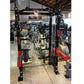 Warrior 2.0 black and red cable crossover pulley power rack with dual weight stacks in gym setting