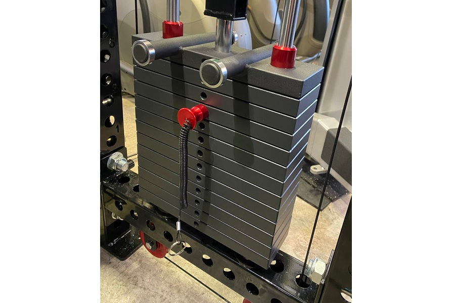 Warrior 3.0 cable crossover pulley power rack with black weight plates, red handles, and dual adjustable pulleys with lat pul