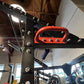 Black and red steel power cage with integrated weight plate storage, red carabiner handles, and silver bolts throughout, disp