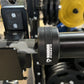 Warrior 6-bearing cerakote barbell bar with gray camo sleeve design, displayed in gym setting