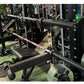 Warrior 6-bearing barbell with red camo cerakote coating and chrome sleeves, displayed on squat rack in gym setting
