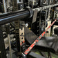 Warrior 6-bearing cerakote barbell with red camo pattern, loaded on squat rack in gym setting