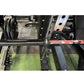 Warrior 6-bearing barbell with black cerakote shaft and red camo sleeve collars, shown on rack
