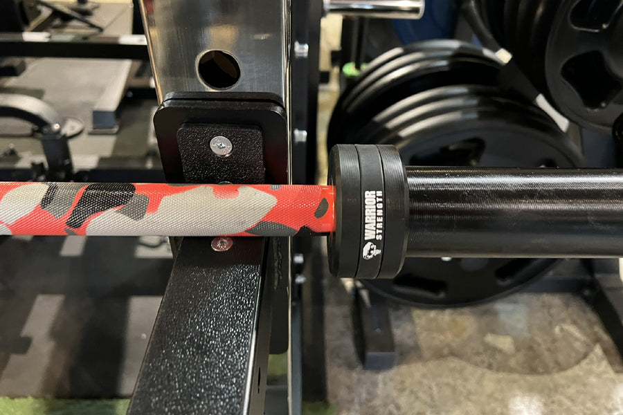 Warrior 6-bearing cerakote barbell with red camo grip wrap and black steel shaft, close-up detail view