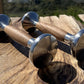 Pair of 2kg stainless steel dumbbells with natural wood handles on wooden deck