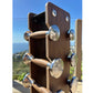 Dark wood dumbbell rack with stainless steel handles and numbered weights from 2.5kg to 12kg, displayed outdoors with ocean v