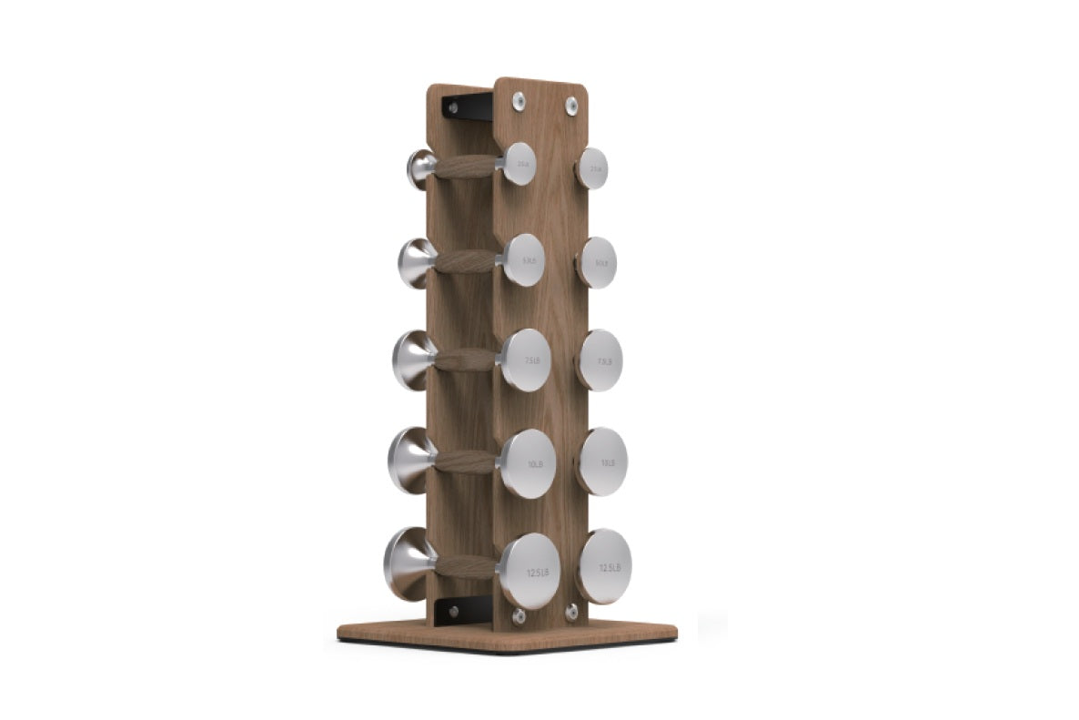 Walnut wood dumbbell tower with five pairs of stainless steel dumbbells ranging from 2.5 to 12 pounds, displayed on white bac