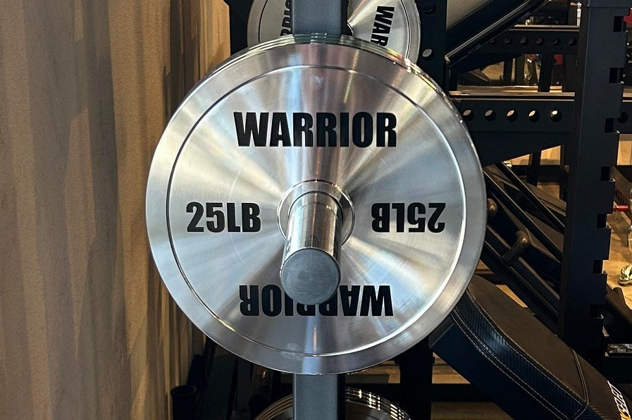 Warrior chrome Olympic weight plate, 25lb, with brushed steel finish and black text markings