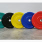 Five Olympic bumper plates in teal, black, yellow, blue, and red with chrome center hubs, displayed on concrete floor