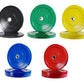 Five color-coded Olympic bumper plates in black, green, yellow, blue, and red with metal centers on white background