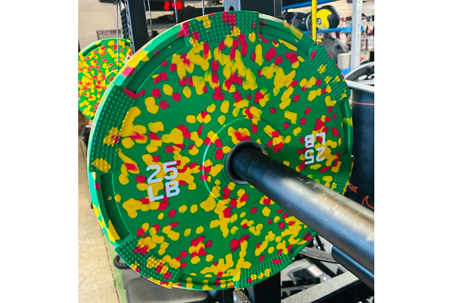 Warrior Fleck green rubber bumper plate with red and yellow speckled pattern on barbell