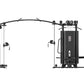 Black multi-station gym equipment with cable machines, weight stacks, and leg press station on white background