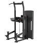 Black commercial assisted chin dip machine with vertical frame, padded seat, and weight stack on white background