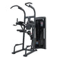 Black commercial assisted chin dip machine with dual handles, padded seat, and control panel on white background