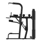 Black commercial assisted chin dip machine with foot platform, dual handles, and weight stack on white background