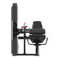 Black commercial leg curl machine with padded seat and backrest, cylindrical leg extension pad, weight stack on left side, an