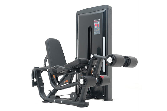 Warrior Pro black leg extension and prone leg curl machine with dual weight stacks and digital display on white background