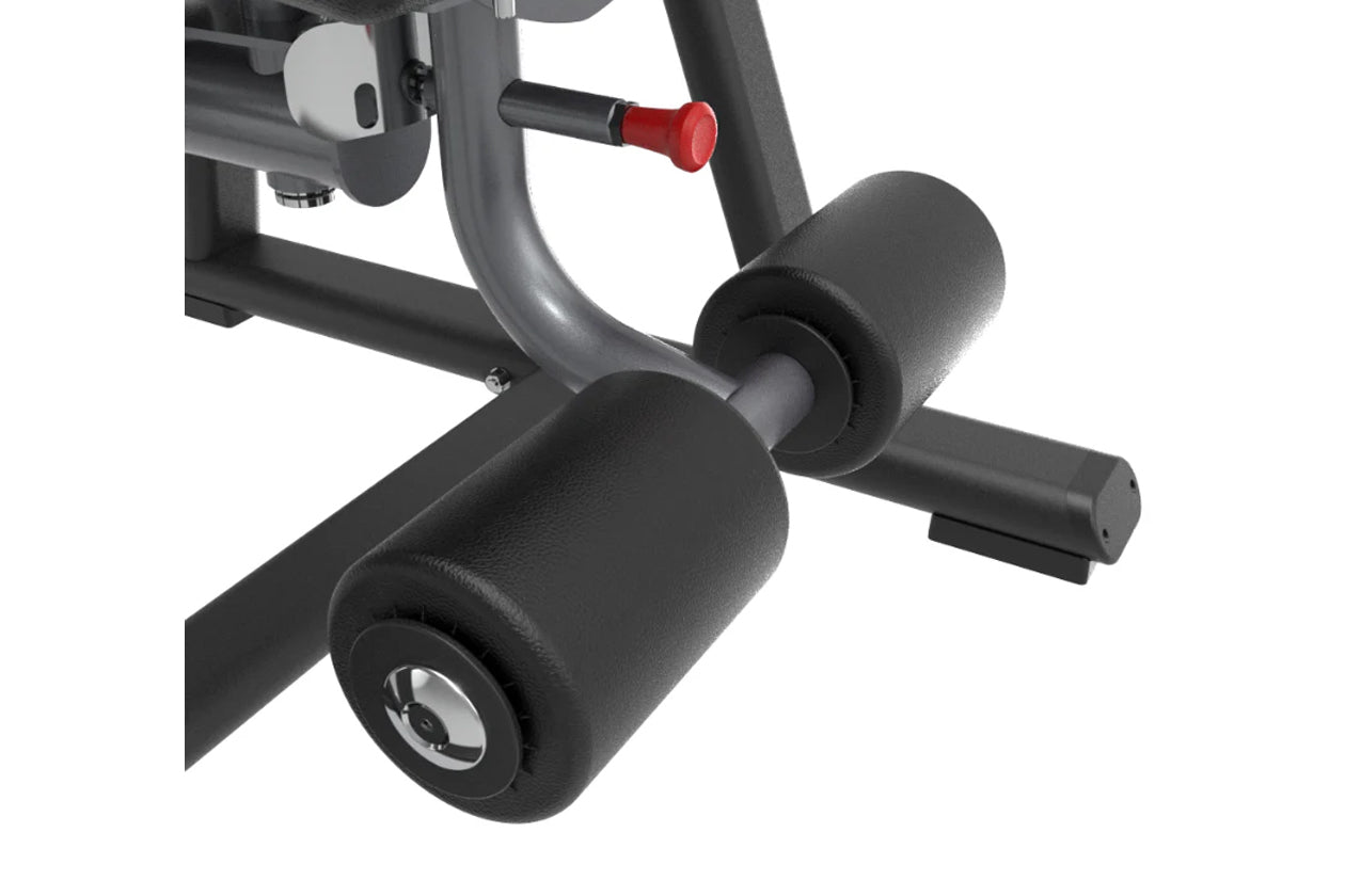 Gray and black upright abdominal crunch machine with padded cylindrical foot platform and red adjustment lever on white backg