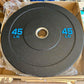 Black rubber bumper plate with blue speckles, 45 lb weight marked in blue text, metal center ring, in cardboard box