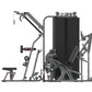 Gray and black commercial multi-station weight gym with stacked plates, cable arms, leg press, and adjustable seat on white b