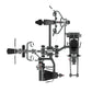 Multi-station home gym equipment with gray metal frame, dual weight stacks, foot pedals, chest press attachment, and leg exte