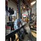 Warrior Deluxe Squat Rack with loaded barbell and weight plates in gym setting