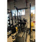 Black and yellow Warrior Deluxe Squat Rack with adjustable barbell holders and safety arms displayed in gym setting