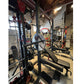 Warrior Deluxe Squat Rack with blue weight plate and black barbell in gym setting