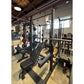 Warrior Deluxe Squat Rack with black uprights, weight plate storage, and adjustable safety bars in gym setting