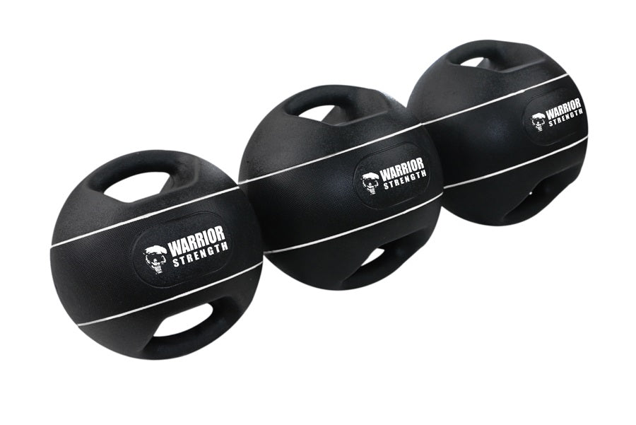 Three black Warrior Strength medicine balls with dual grip handles and white stripe detail on white background