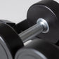 Black urethane dumbbell with textured gray grip and chrome collar detail, displayed among other dumbbells on white background