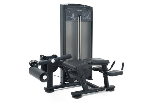 Warrior Elite commercial leg curl machine with black upholstered seat and footrest, metal frame, weight stack, and control pa