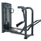 Black commercial standing rear kick machine with padded footplate and curved handles on white background