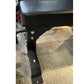 Black flat weight bench with wheels and metal rivets, side view on concrete surface