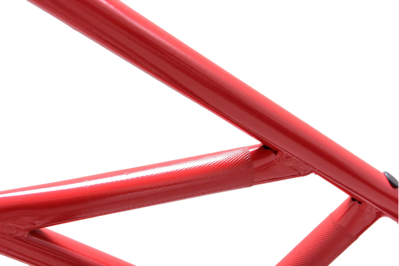 Red steel power rack frame with welded joints and textured grip areas on white background