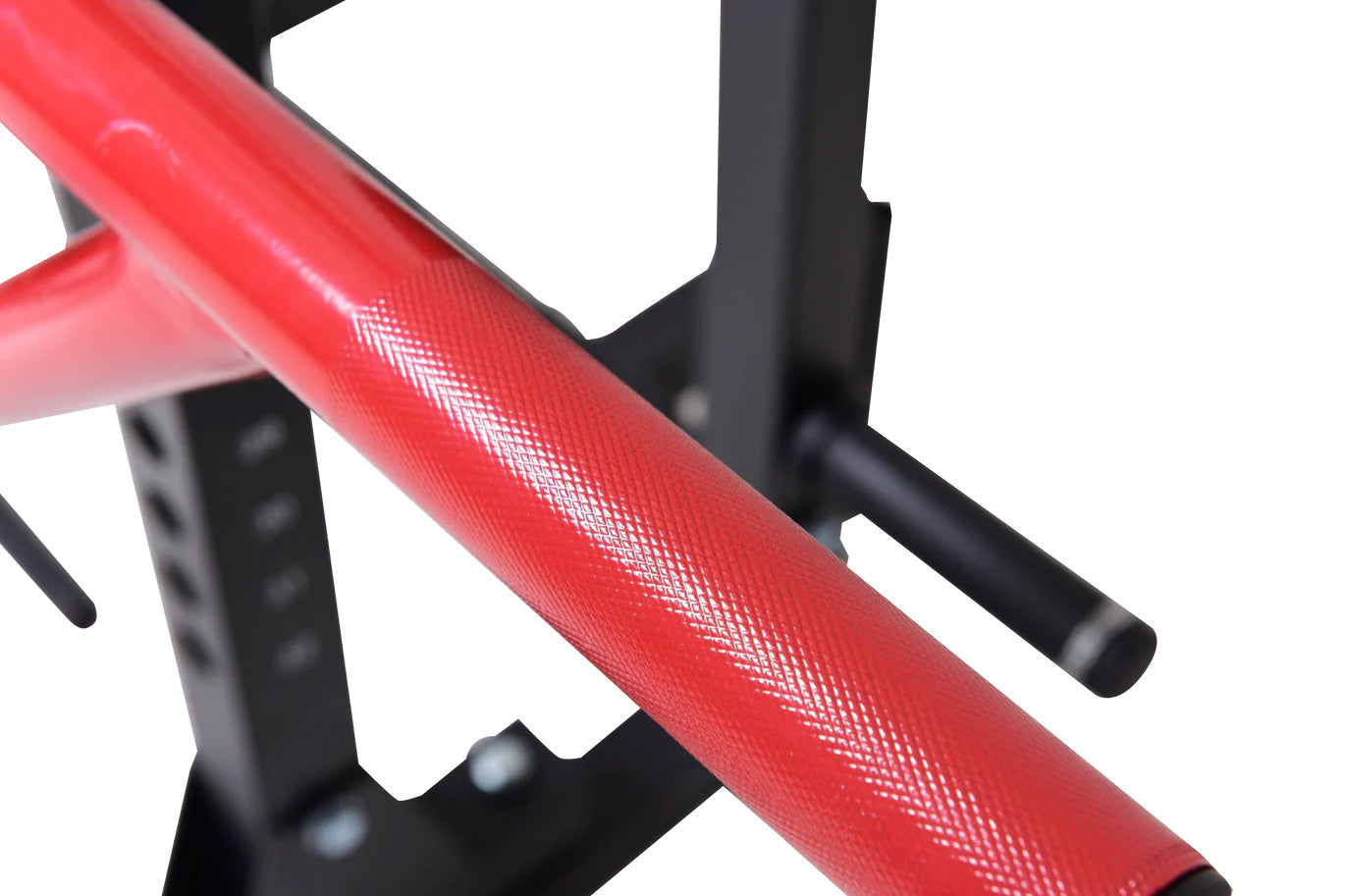 Red and black cable pulley power rack frame with textured red tube and black metal supports on white background