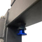 Black metal power rack with blue pulley attachment and gold-toned pin detail on white background