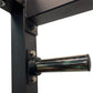 Black steel power rack corner joint with chrome pulley attachment and metal bolts on white background
