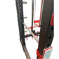 Black steel power rack with red and white pulley system, adjustable height pins, and cable attachments on white background